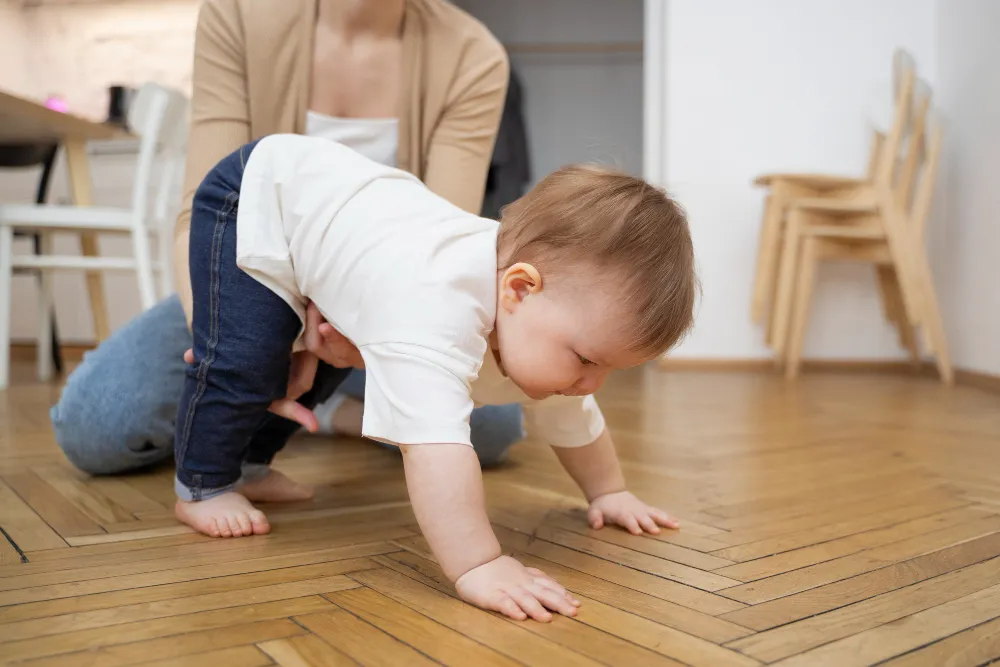 baby practising crawling on all four